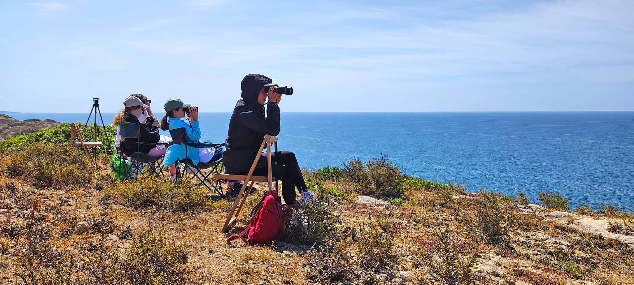 Thao Mai with binoculars on sea coast