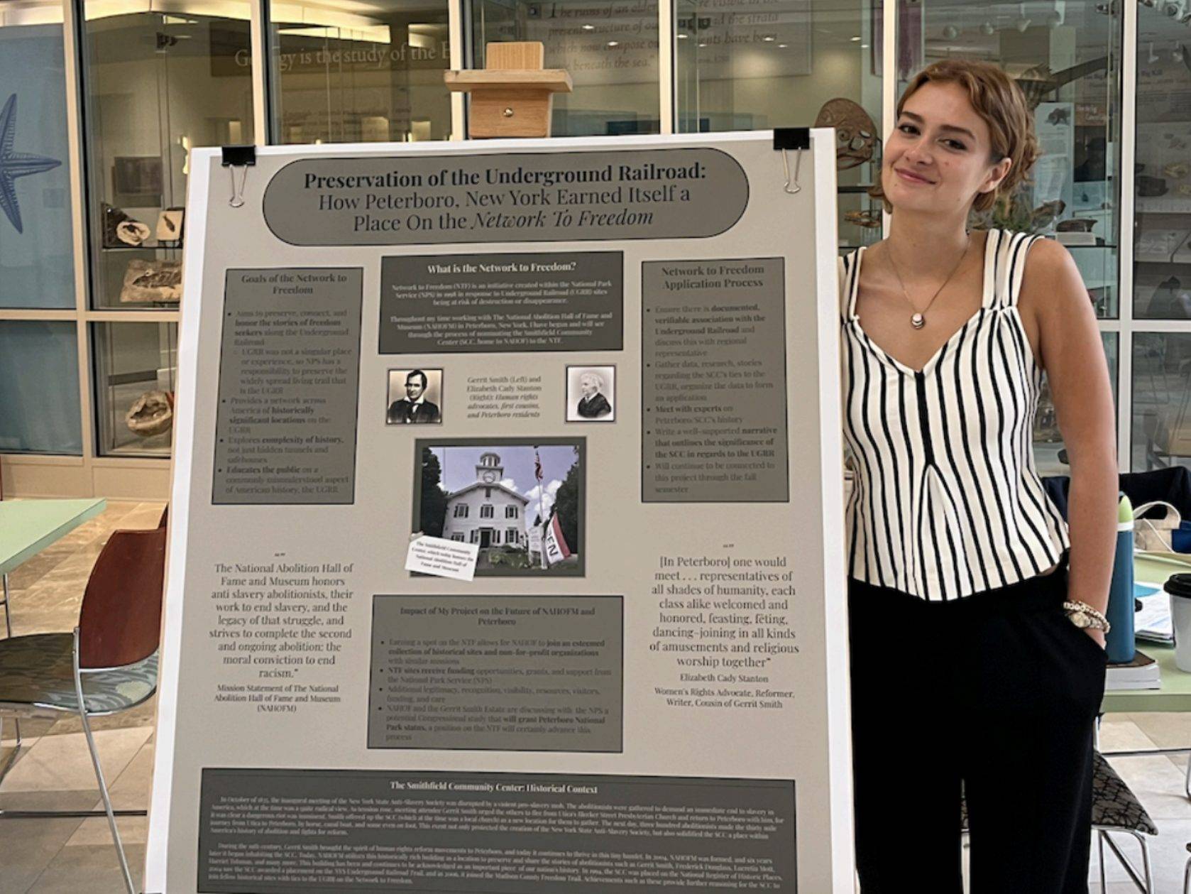 Eliza Potter ’26 stands with her poster at a poster session July 25, 2025 about her work with National Abolition Hall of Fame during her Upstate Institute Field School Fellowship.