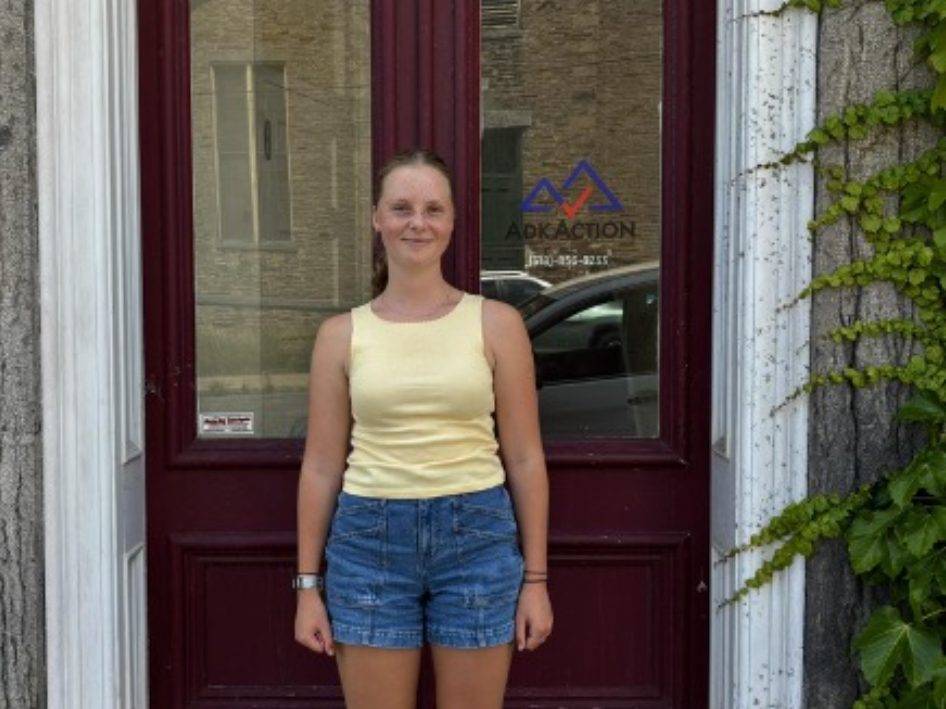 Jessica Lee ’27 stands in front of the AdkAction office, where she was a Summer Field School Fellow.