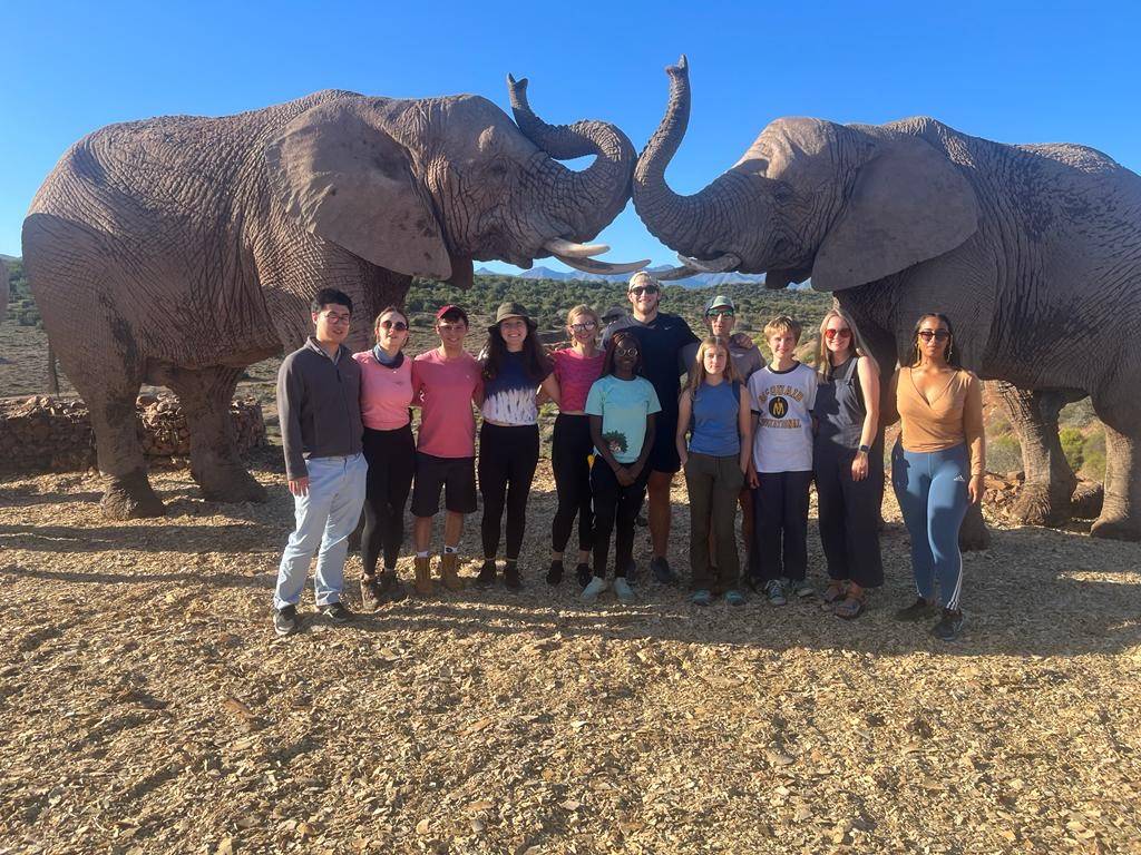 Jason Qian '24, Rebecca DiVirgilio '24, Joe Berberich '24, Catie Mooney '24, Emily Balog' 24, Mariama Lemon '24, Will Andersen '23, Professor Mike Loranty, Cora, June, Erin Loranty, and Professor Tammy Wilks (University of Cape Town Faculty).