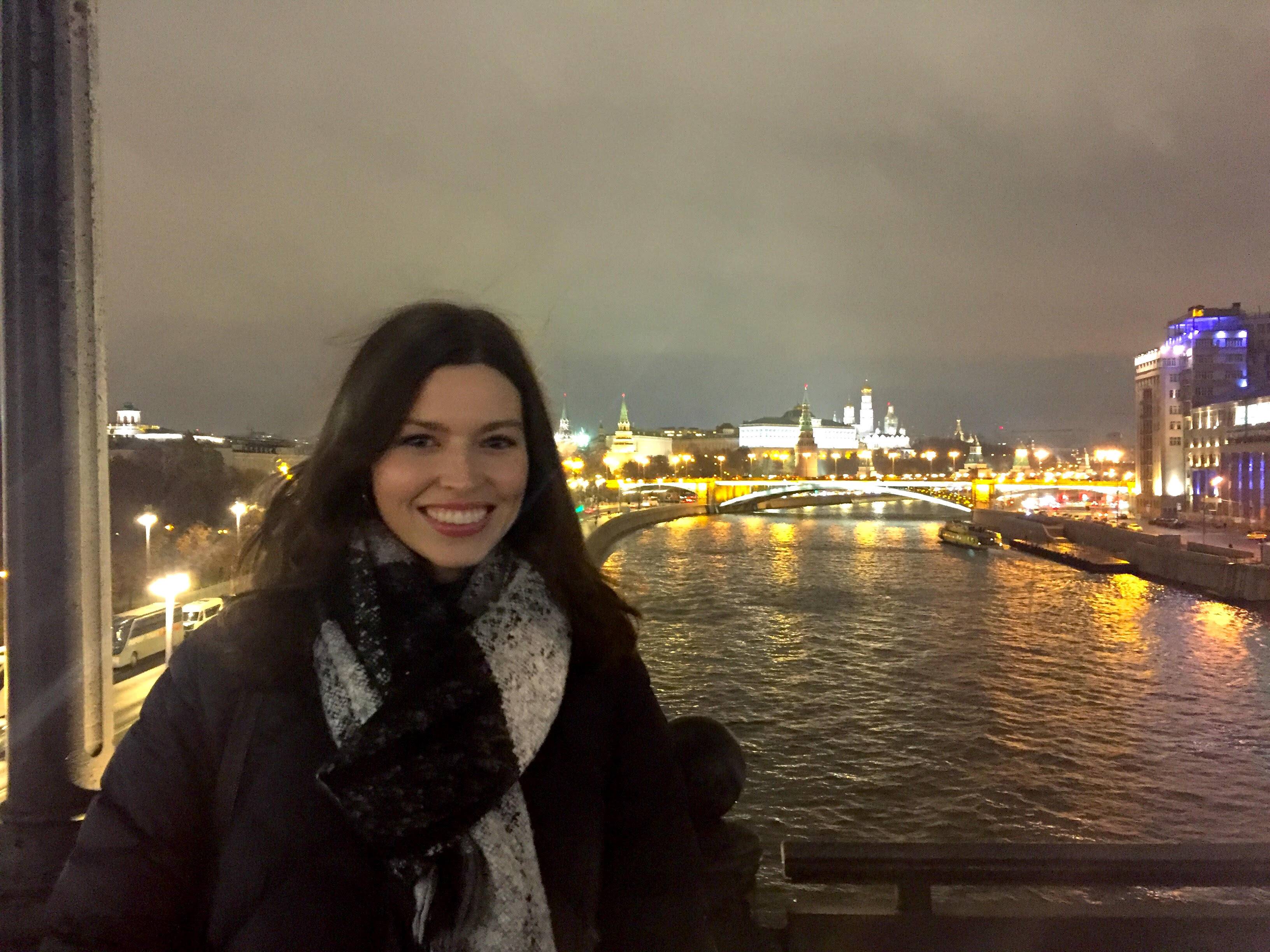 Lindsey stands on a bridge in front of the Volga River in Moscow