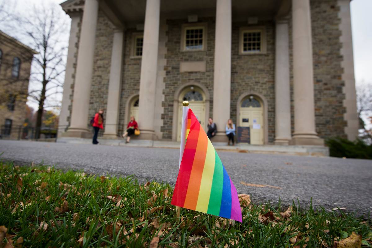 Closeup of rainbow pride flag in front of Colgate Memorial Chapel