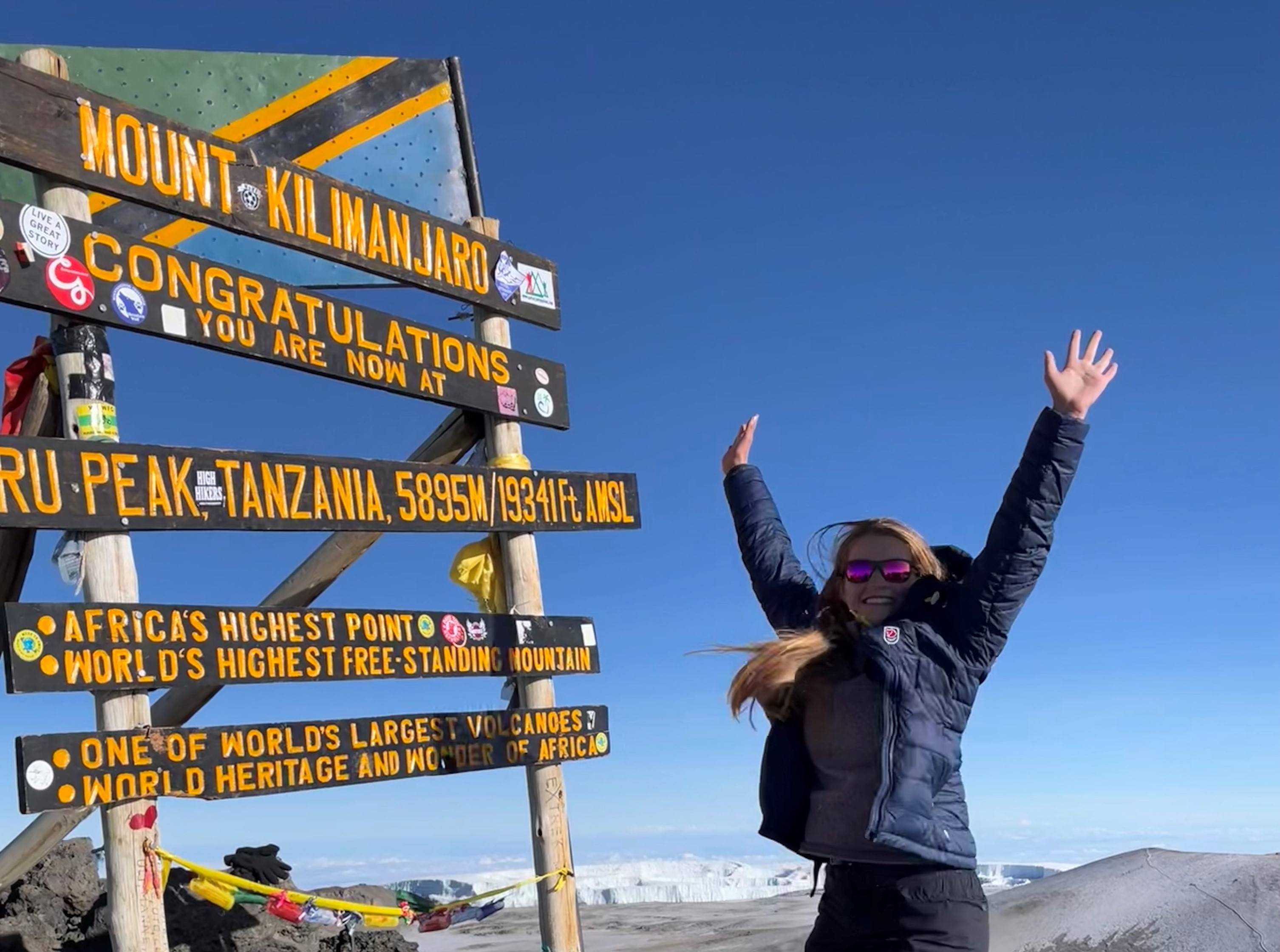 Emily Balog ’24 at signpost on summit of Mount Kilimanjaro, Tanzania.