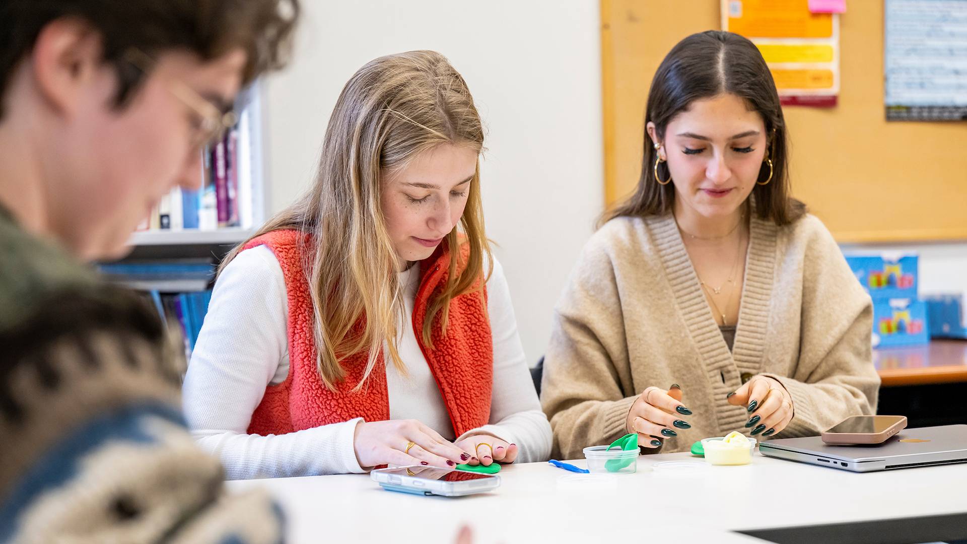 Students create miniature offerings out of clay to celebrate Alasitas