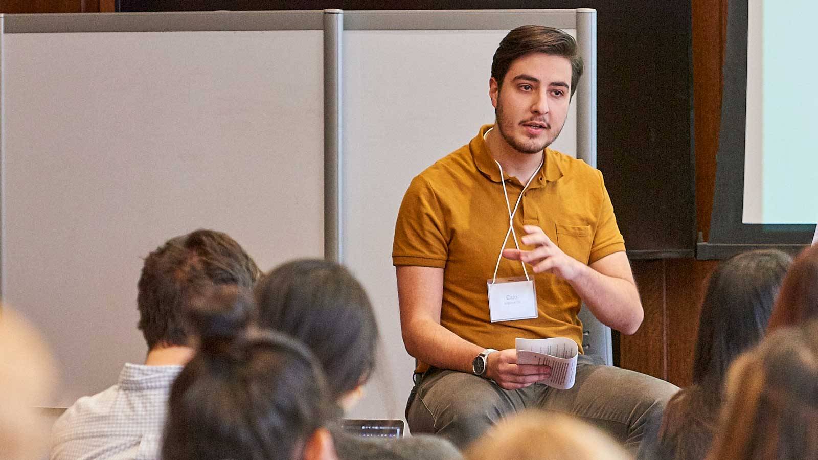 Caio Brighenti ’20 speaks to a group