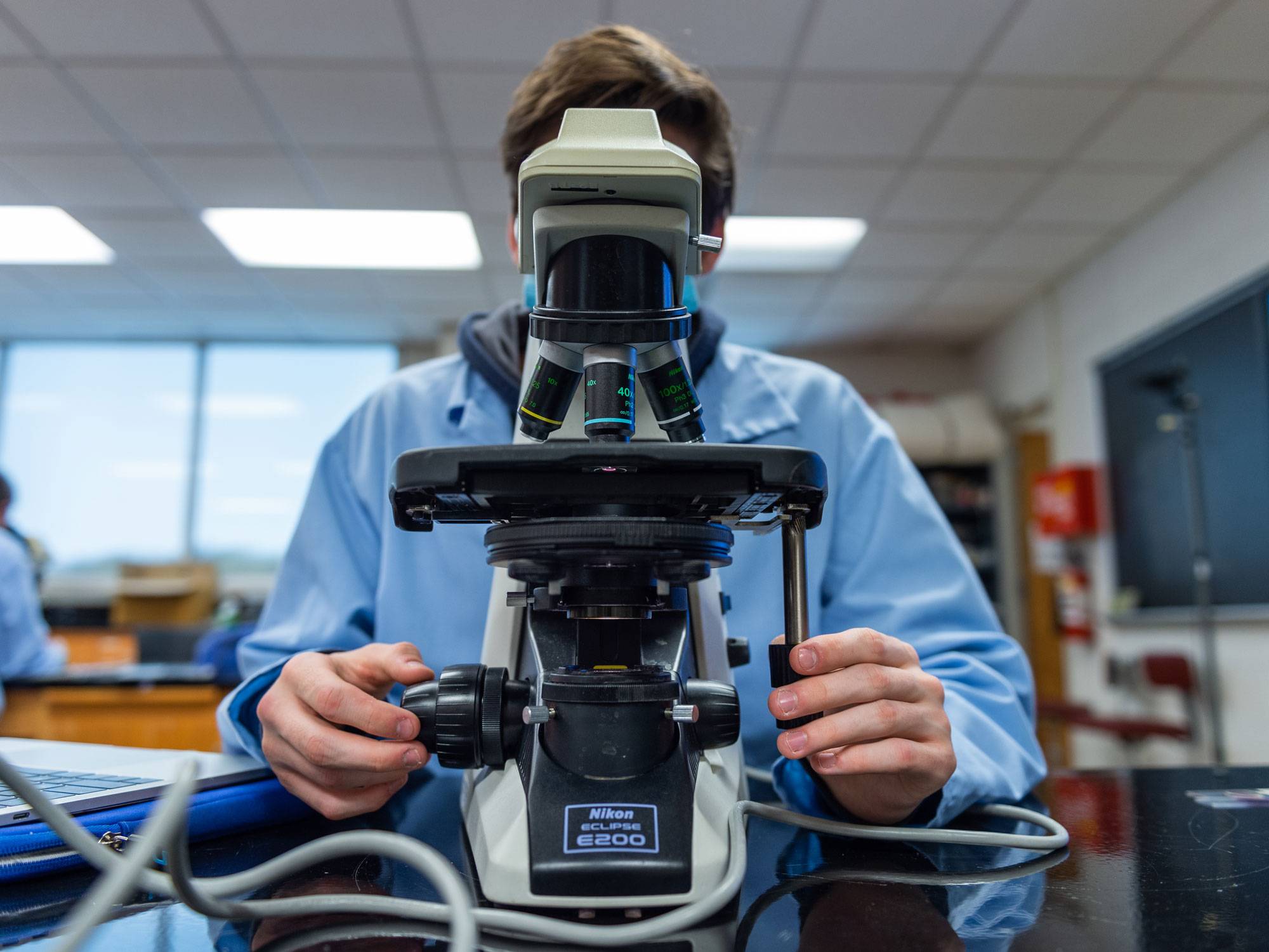 student at microscope