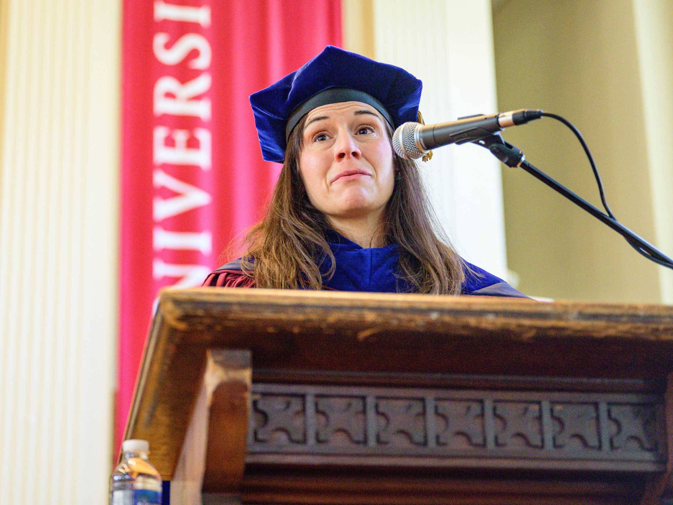 Professor Janel Benson at podium