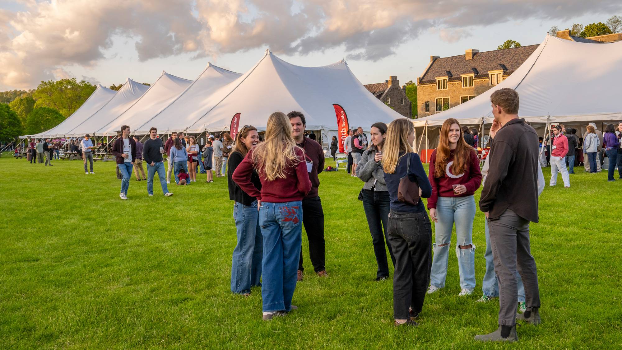 People stand in front of reunion tents