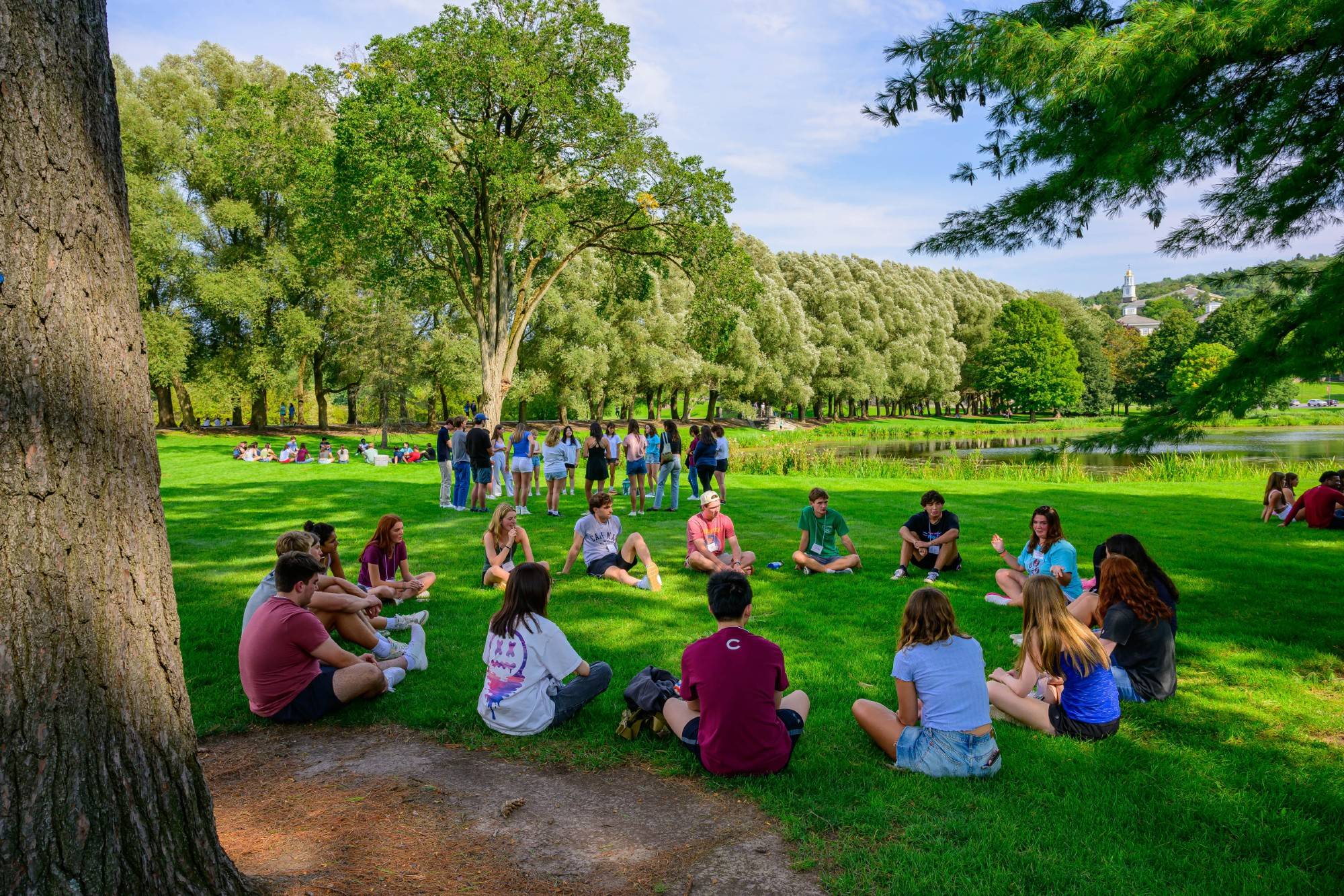 A group of students sit in a circle near Taylor Lake