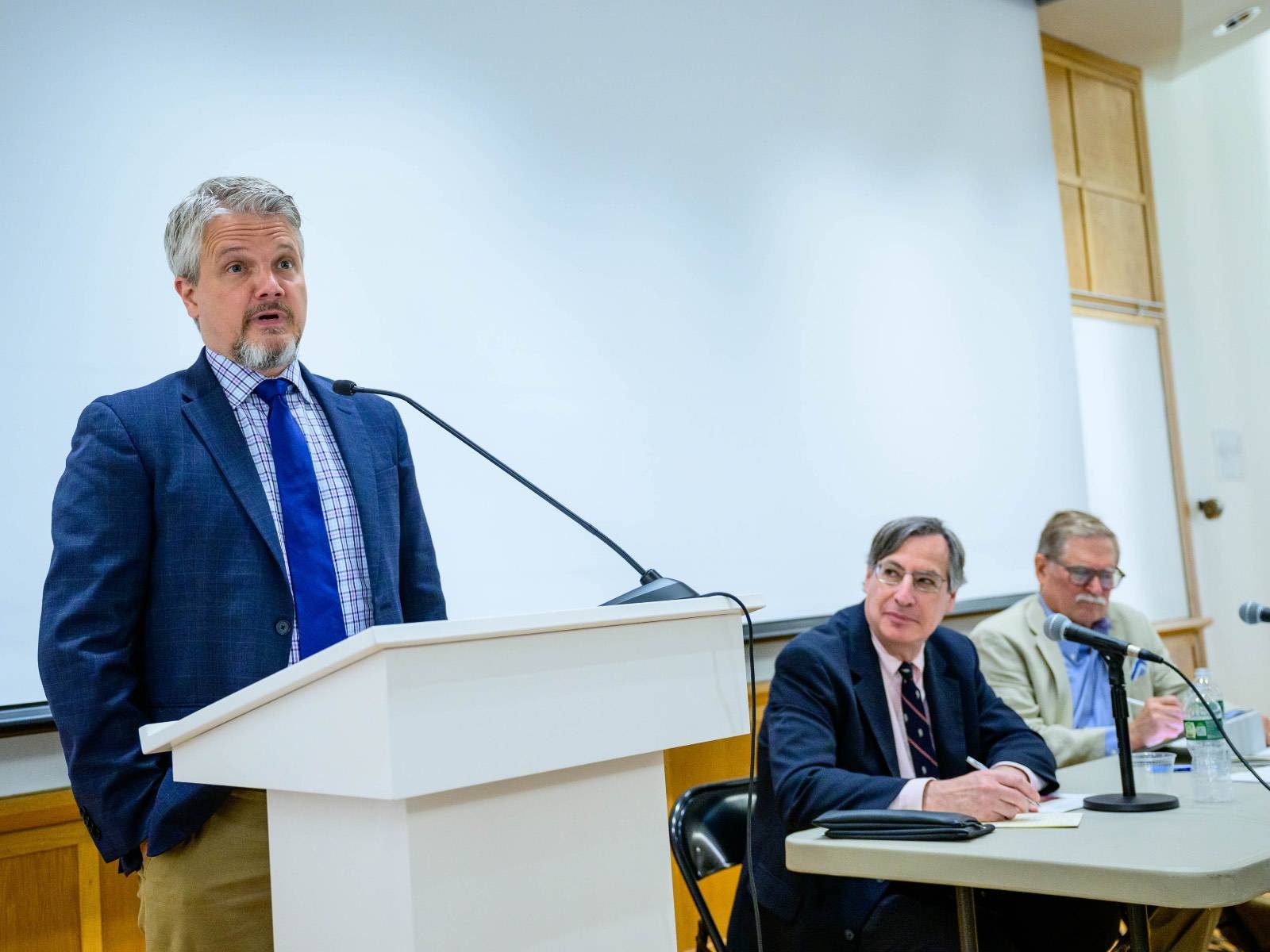 Julian Davis Mortenson, James G. Phillipp Professor of law at the University of Michigan, speaks during Colgate’s Constitution Day Debate Sept. 13, as Gary Lawson, Philip S. Beck Professor of law at Boston University, and debate moderator and Professor of Political Science Stanley Brubaker listen, seated at a table.