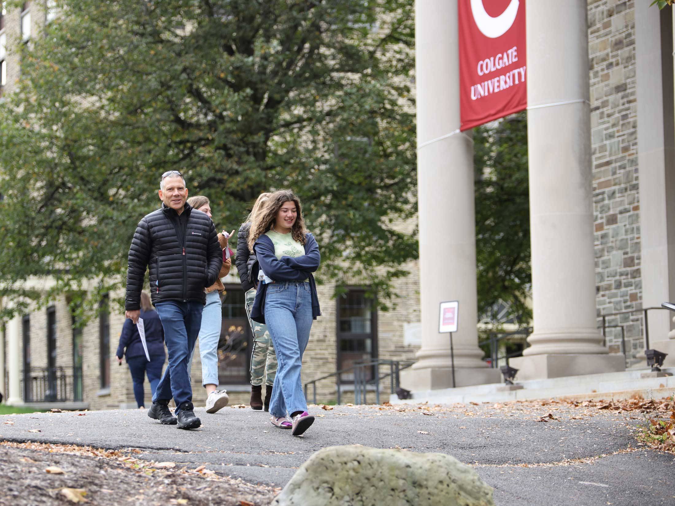 Student and family member walk in front of Memorial Chapel