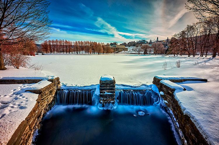 Frozen Taylor Lake on a winter day with campus in the background