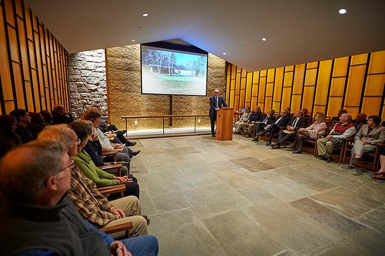 Vassar professor Nicholas Adams delivers lecture at podium in the Chapel House Sanctuary