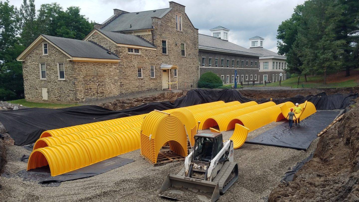 Workers install underground storage chambers to capture stormwater runoff