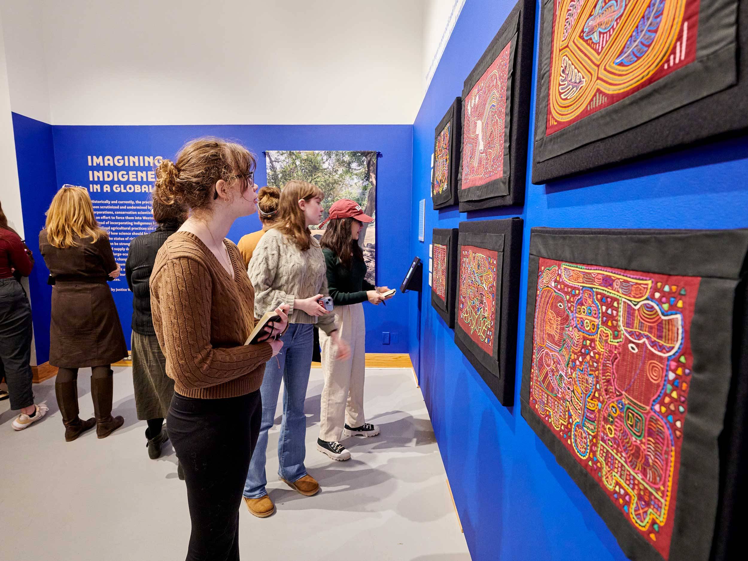 Museum visitors view hand-stitched molas