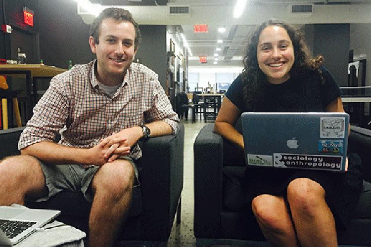 Erica Pais '17 sitting with a laptop at Chicory headquarters with founder Joey Petracca '13