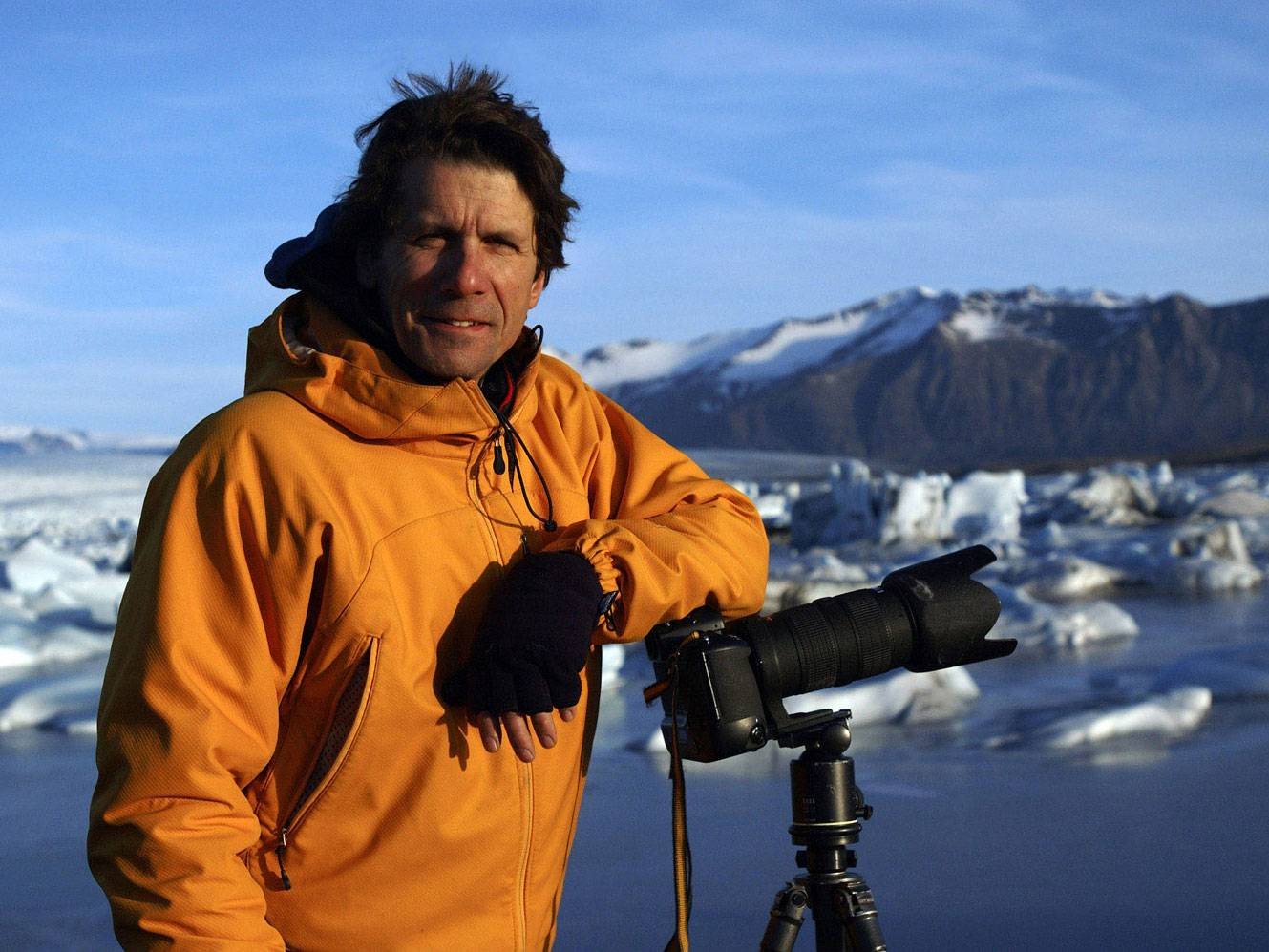 James Balog stands next to camera in arctic environment