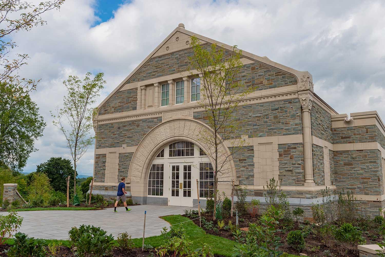 Student walks to the front door of Benton Hall. The building is named after lead donor and alumnus Dan Benton '80.