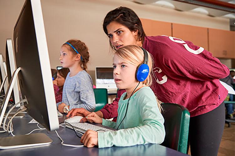 Colgate Women in Computer Science students help teach coding to local elementary school students.