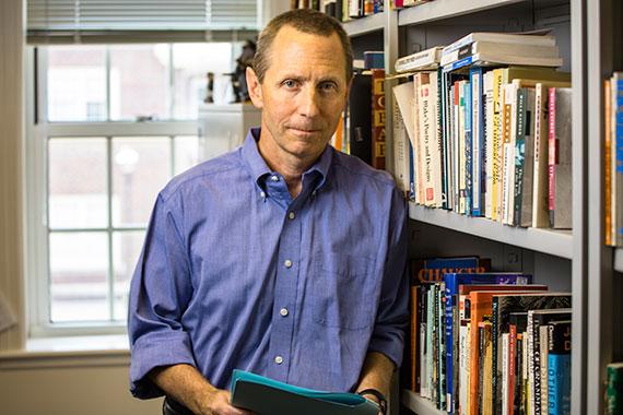 Man standing near book shelf