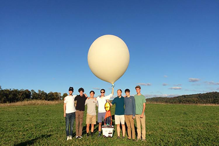 The Engineering Club members prepare to launch their weather balloon.