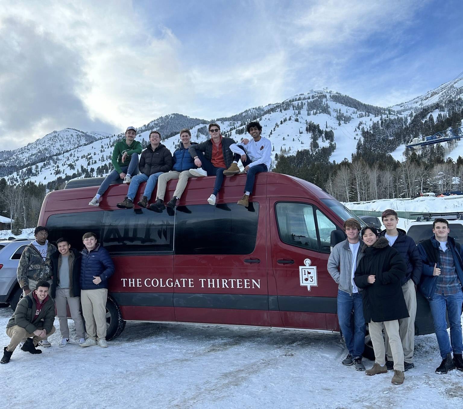 Members of the Colgate Thirteen gathered around their van