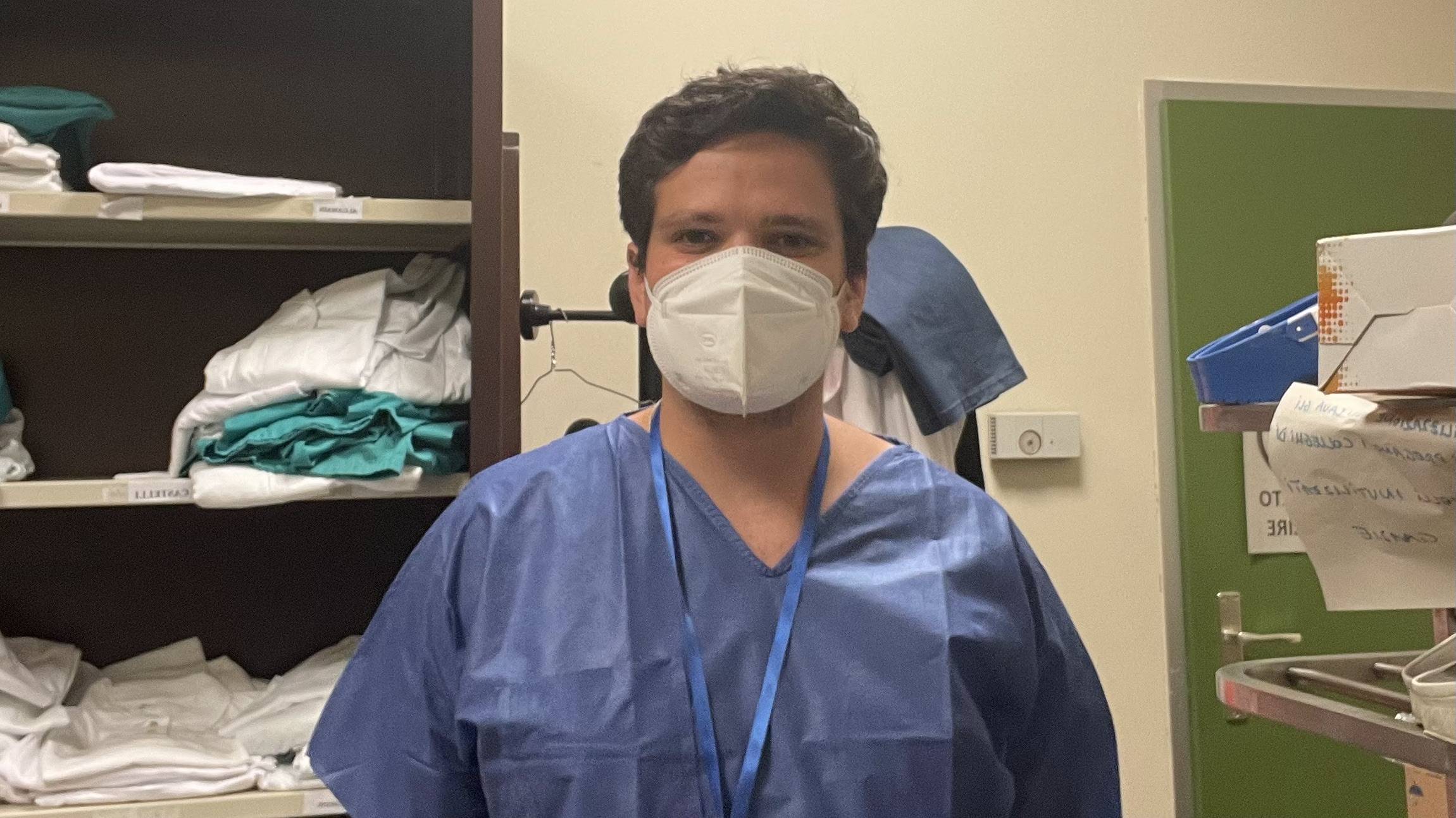 Clay dressed in scrubs, prepared to observe a surgery