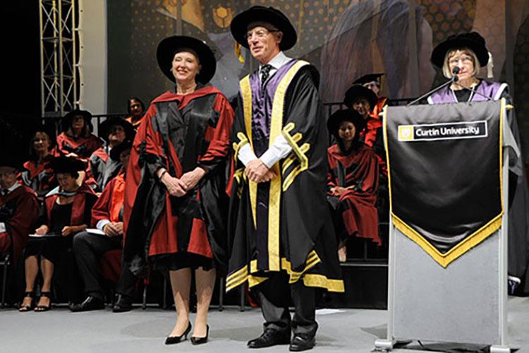 Professor Ellen Kraly stands on the commencement stage with Curtin University Chancellor Mr. Colin Beckett and Vice-Chancellor Professor Deborah Terry