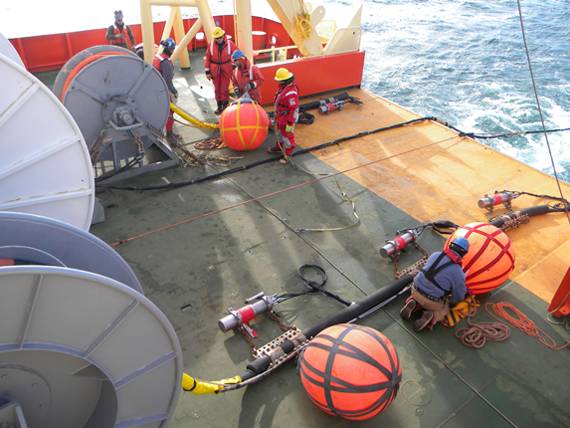 Scientists inspect equipment aboard ship