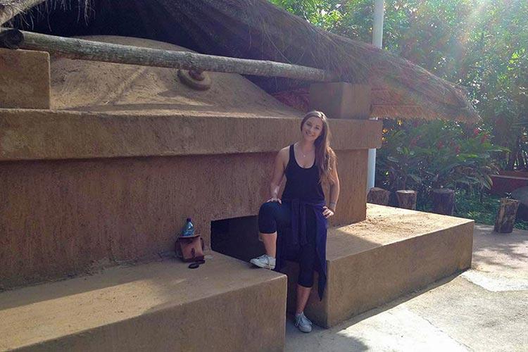 Hannah Robinson ’11 stands outside a Mayan steam bath in Guatemala.