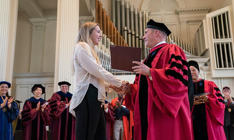 Colgate's 1819 Award winner receives the award from Colgate President Brian W. Casey in the Colgate Memorial Chapel.