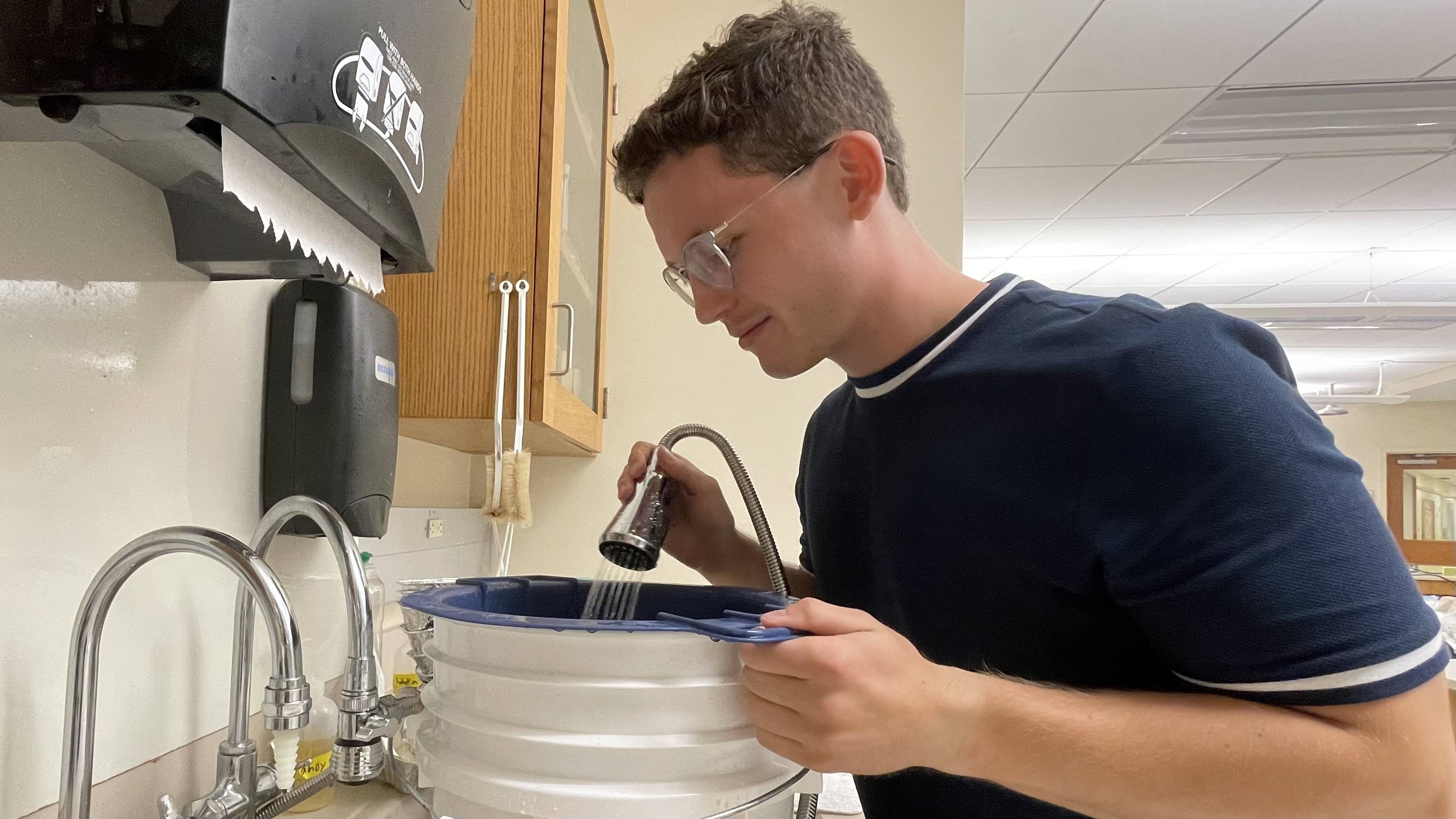 Ryan working in the lab to separate volcanic materials or tephra by grain size