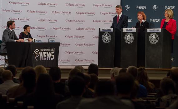 Three candidates for the 22nd Congressional District seat standing at podiums at the debate in the Memorial Chapel at Colgate University