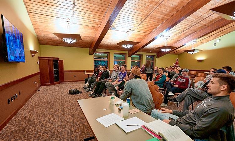 Student gathering in a public TV room to watch Ryan Diew '17 on Shark Tank