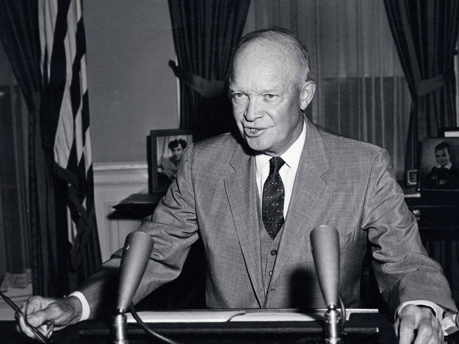President Eisenhower sits at desk