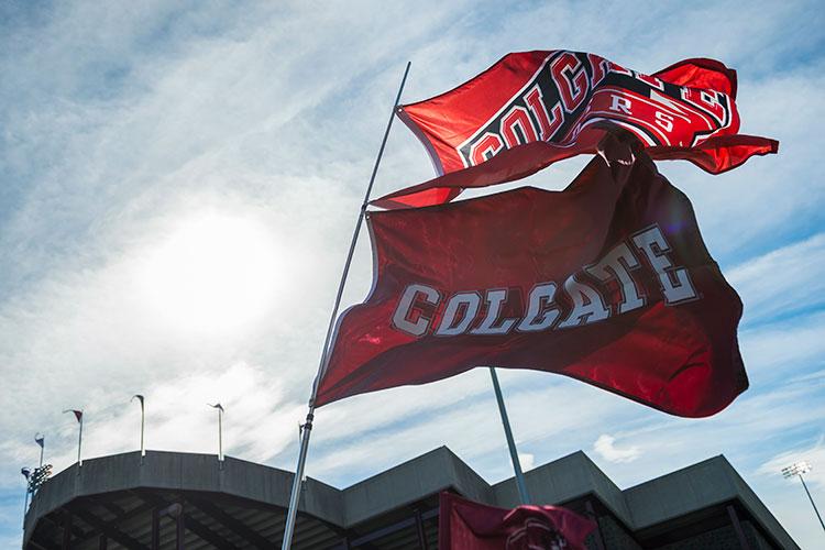 Colgate and Raider athletics flags fly beside Andy Kerr Stadium