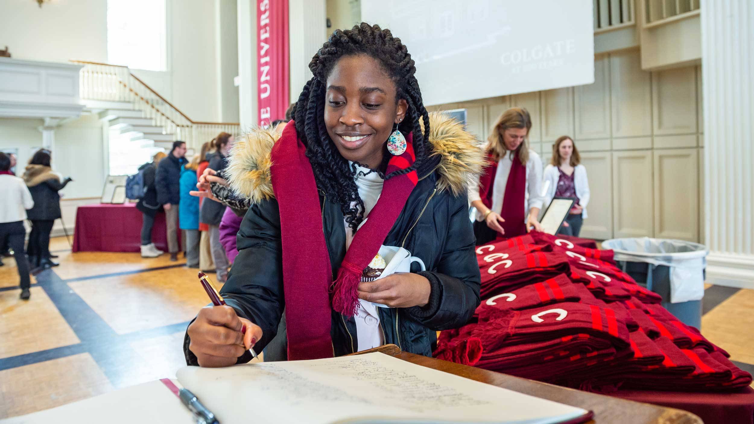 Staff member signs Bicentennial Book