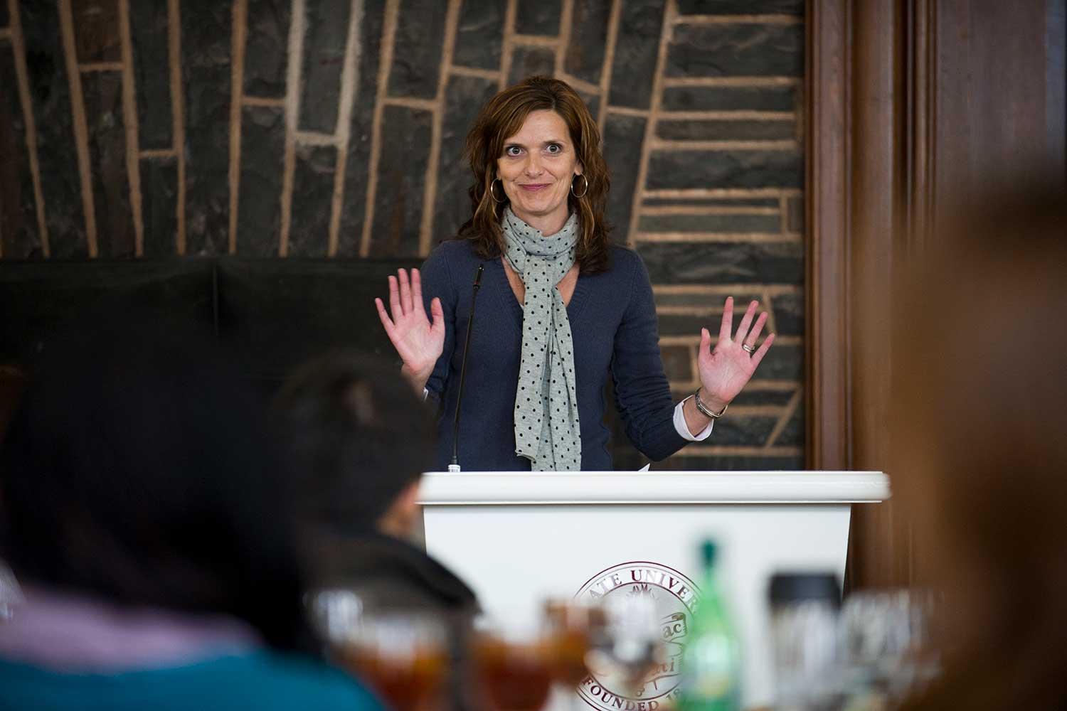 Carrie Clifford ’93, writer and actress, stands at podium to deliver keynote address at Real World 2011.