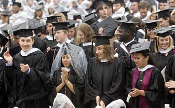 Members of the Class of 2006 applaud during Sunday's chilly and wet commencement.