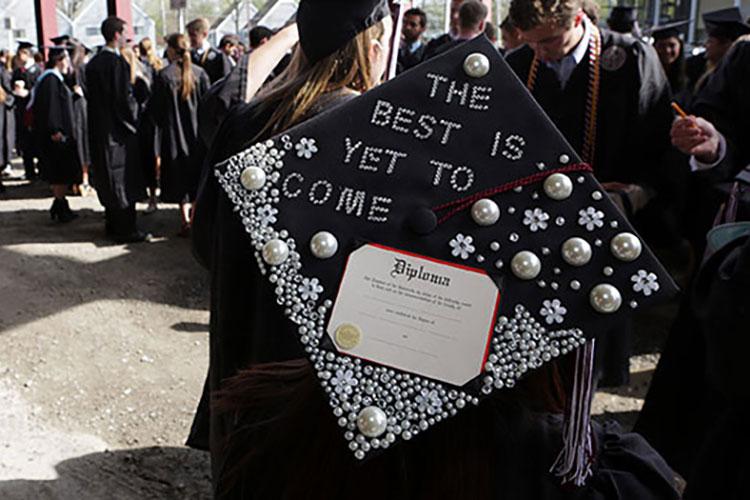 Glitter-adorned graduation cap that reads "The best is yet to come"