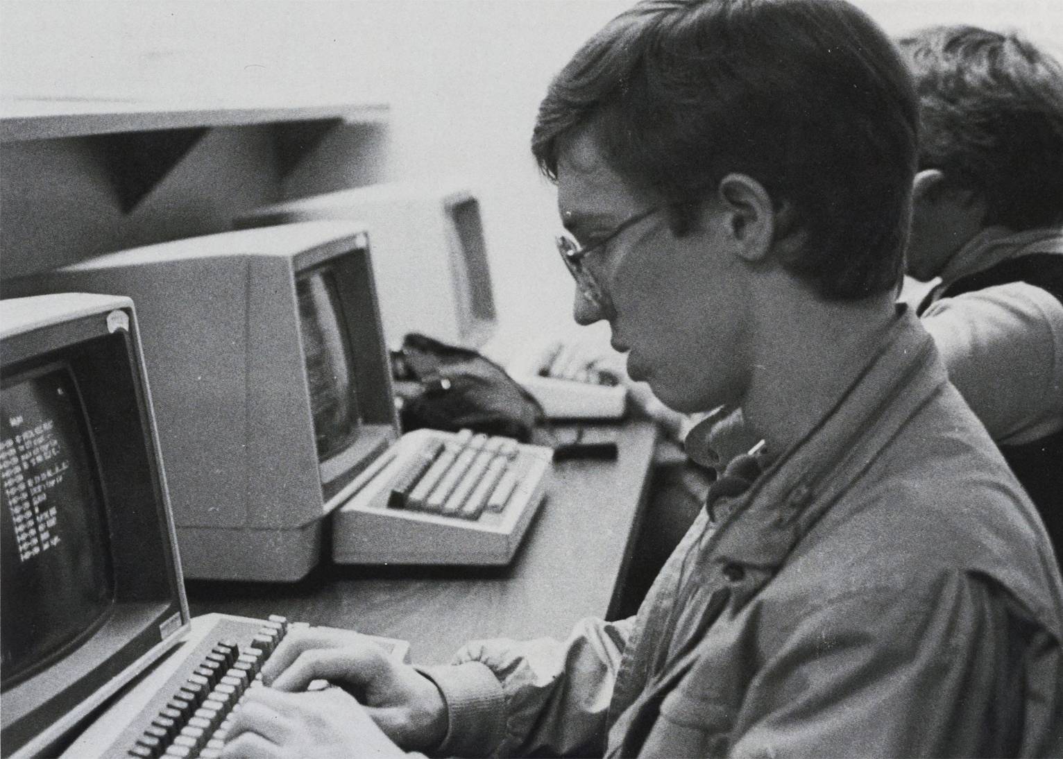 Student sits at computer ca. 1985