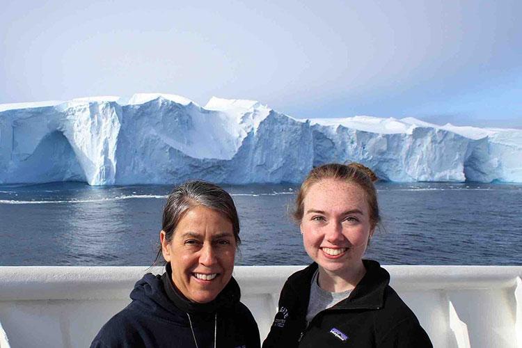 Meghan Duffy ’18 and Professor Amy Leventer stand on ship's deck in front of iceberg