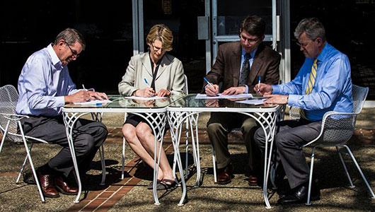 Administrators collaborate at a shared table