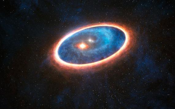 This is an artist’s impression of the triple star system GG Tau A