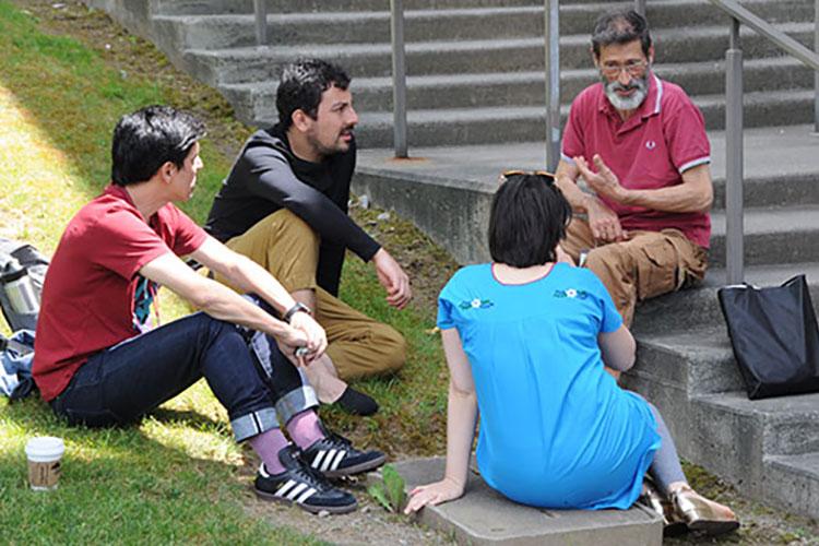 Flaherty Film Seminar participants sit outside and engage in conversation