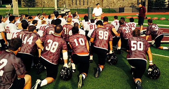 President Jeffrey Herbst speaks to members of the football team.