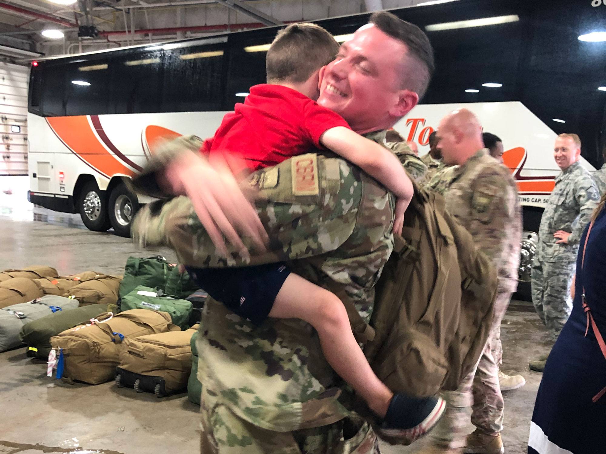 AVP Joe Hernon hugs his son while preparing for deployment