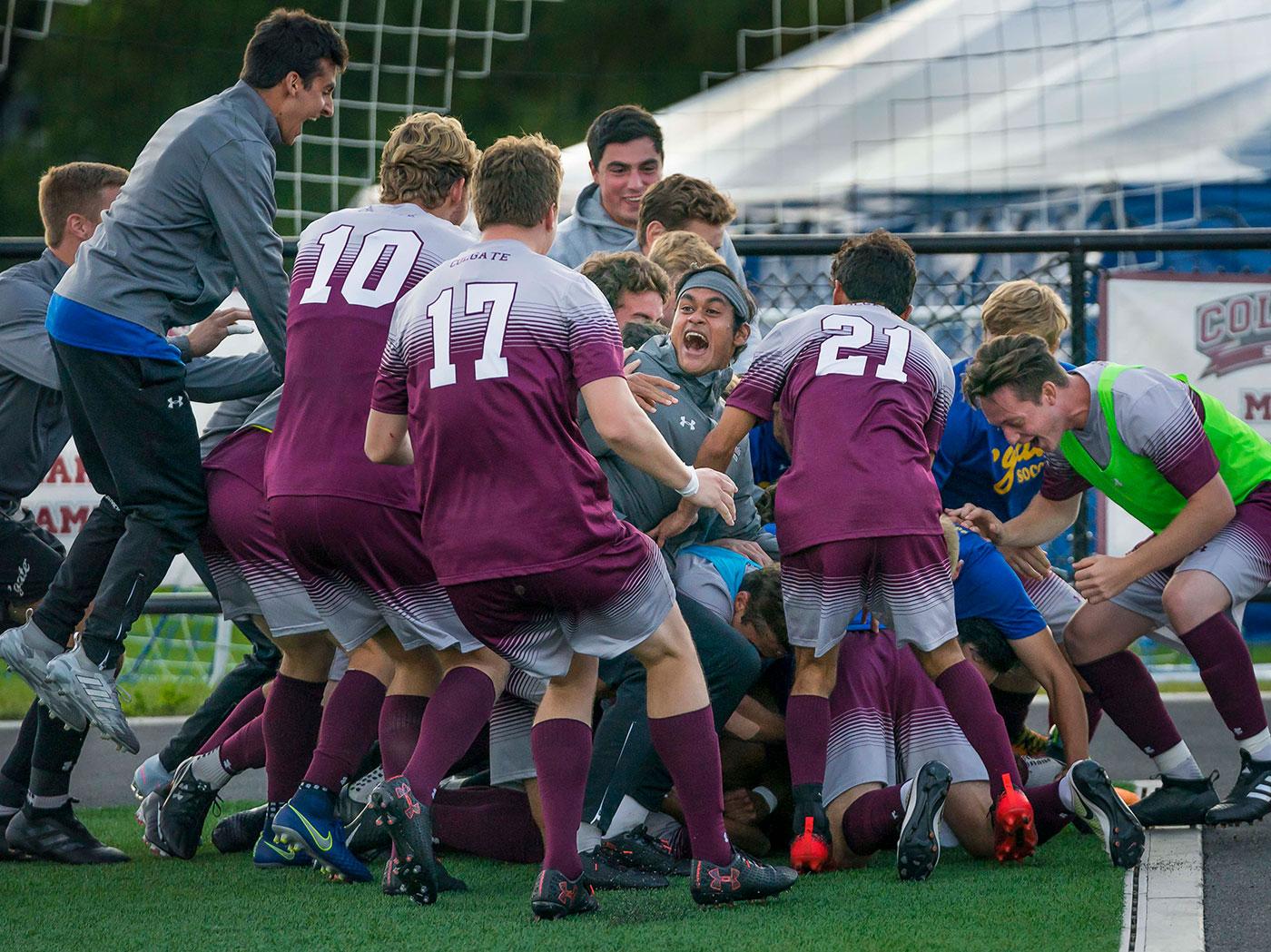 Soccer team piles up to celebrate