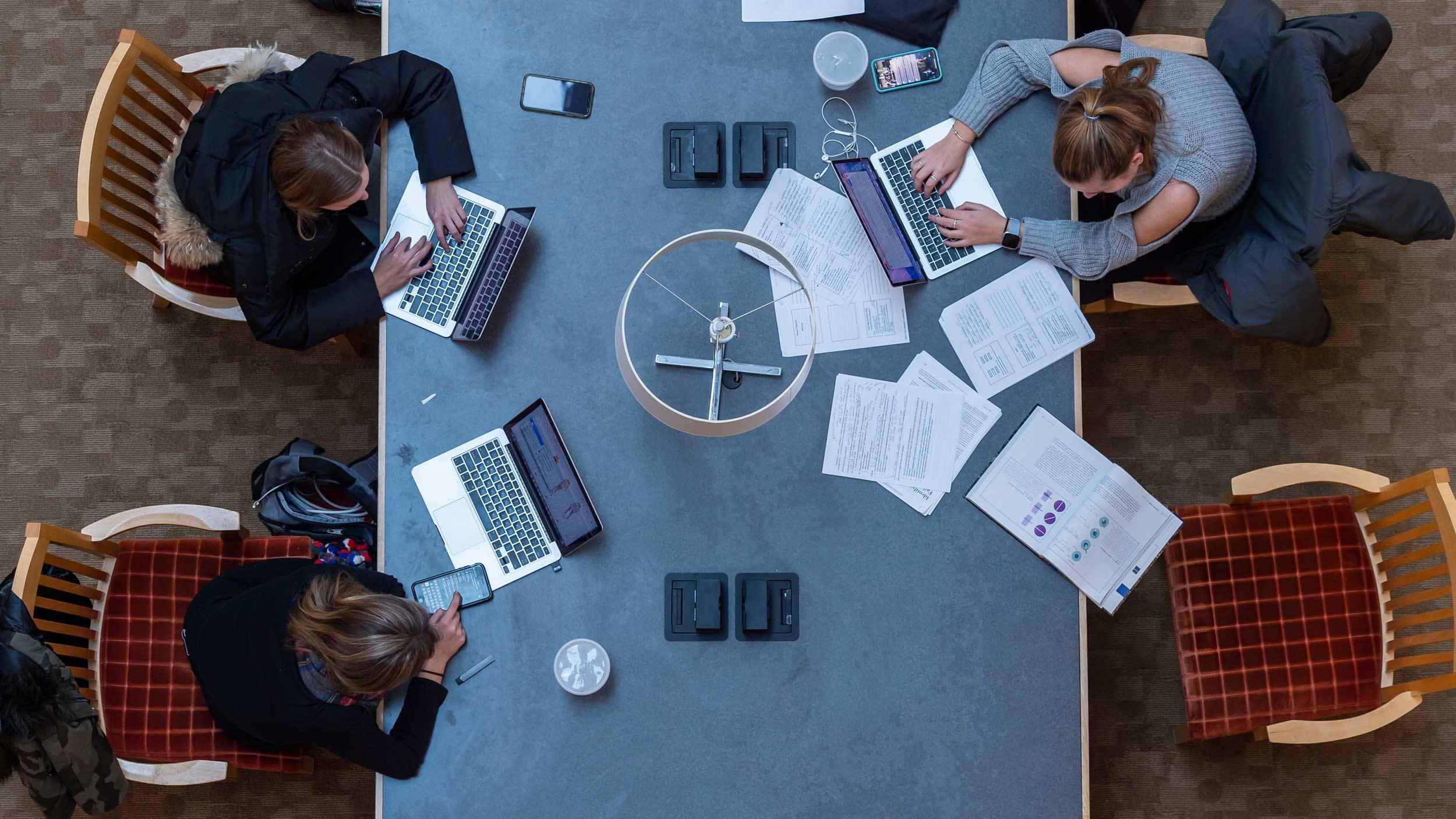 Students work at a table in the Case-Geyer Library — viewed from above