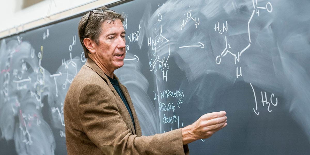 Chemistry professor Ernie Nolen at the chalkboard